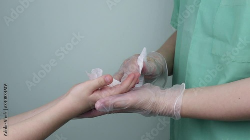 Wallpaper Mural Medicine and health care, the doctor disinfects the little girl's hands with a special napkin Torontodigital.ca