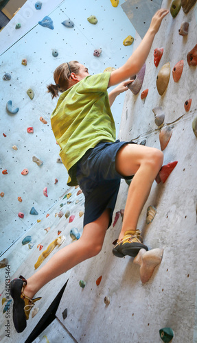 Teenage Boy Training On Climbing Wall
