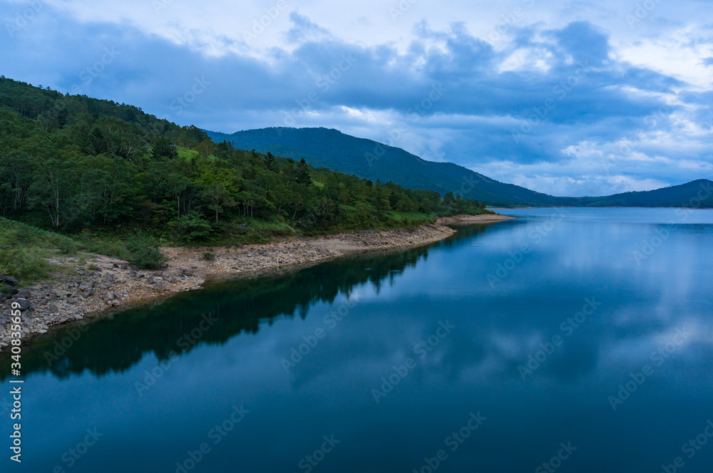 Mountain lake landscape. Nozori lake, dam surrounded by mountains Mountain lake landscape. Nozori lake, dam surrounded by mountains