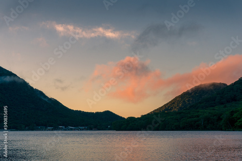 Mountain lake landscape at sunrise with colorful sky