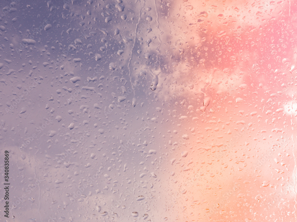 Wet window with rain drops and a cloudy sky outside. Wet window with rain drops and a cloudy sky outside.