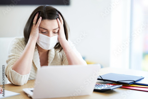Exhausted mother trying to work at home during coronavirus pandemic