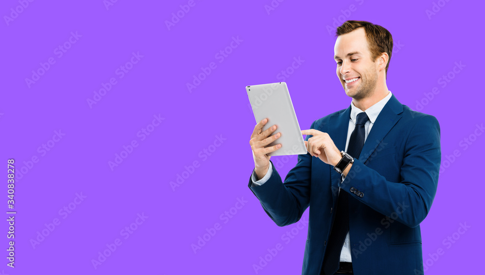 Portrait of smiling businessman using no-name tablet pc, over violet purple color background. Success in business concept studio picture. Copy space for some text. Portrait of smiling businessman using no-name tablet pc, over violet purple color background. Success in business concept studio picture. Copy space for some text.