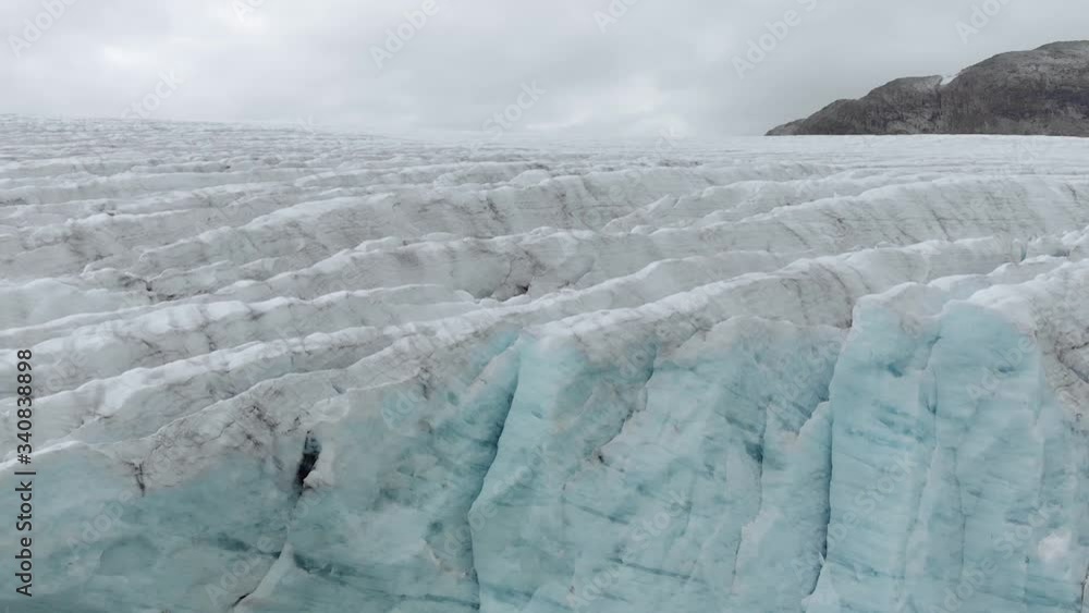 An aerial shot flying up at the front of a glacier, revealing it´s size. An aerial shot flying up at the front of a glacier, revealing it´s size.