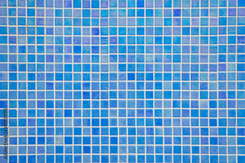Ocean blue swimming pool mosaic tiles background, textured pool walls with copy space, a summer vacation inspiration, traveling to a tropical destination or relaxing holidays atmosphere concepts