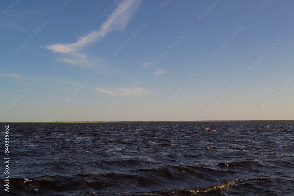 Fototapeta premium Sunset over the sea a bright summer day