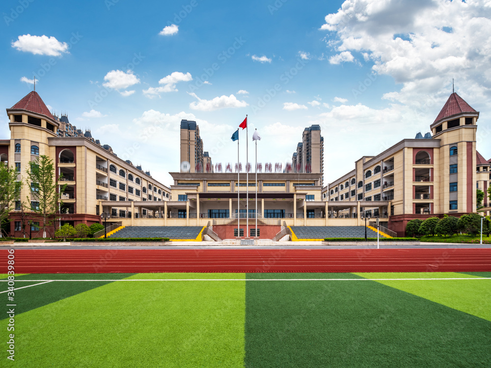 Fototapeta premium School football field and red running track