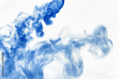 Puffs of paint in water. The dissolution of the dye in water. Water pollution. Concept art creativity.