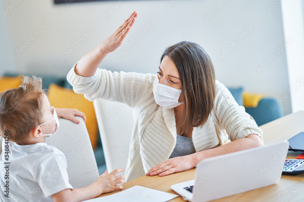 Boy and exhausted mother trying to work at home during coronavirus pandemic Boy and exhausted mother trying to work at home during coronavirus pandemic