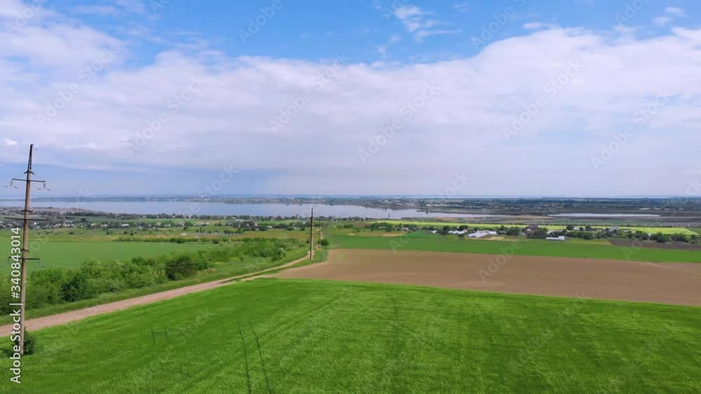 Ukraine. Spring. Countryside. Green field. A river flows in the background. Drone. Aerial view. The camera moves up. Ukraine. Spring. Countryside. Green field. A river flows in the background. Drone. Aerial view. The camera moves up.