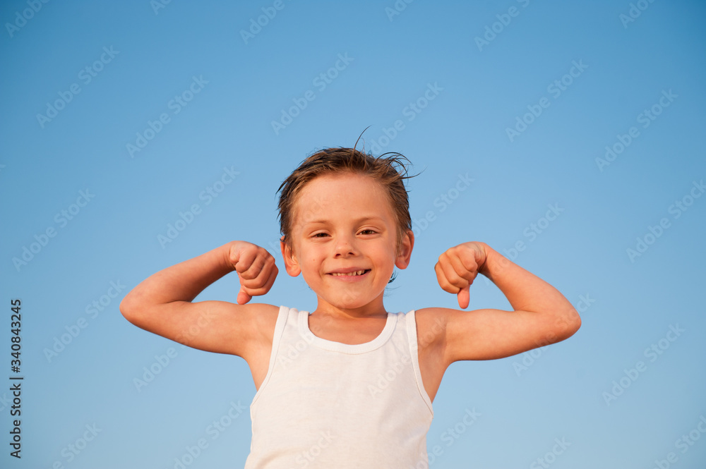 happy healthy little athlete kid in white tank top on blue sky background happy healthy little athlete kid in white tank top on blue sky background