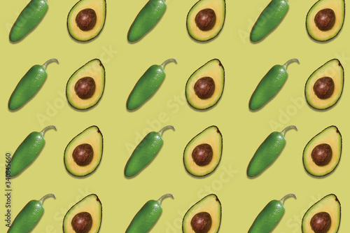 patterns of delicious avocados and jalapeno peppers on green background