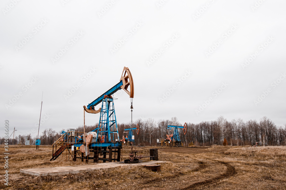 Green Oil pump oil rig energy industrial machine for petroleum crude. oil crisis. Russia pumps oil pollution.