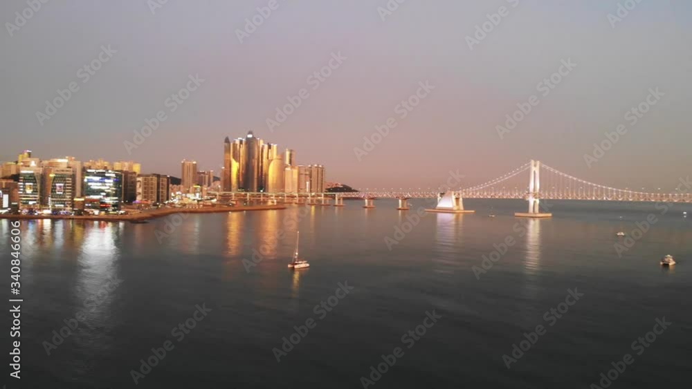 Drone 4K Haeundae Beach Busan Gwangandaegyo Bridge Sunset Evening golden hour showing city Drone 4K Haeundae Beach Busan Gwangandaegyo Bridge Sunset Evening golden hour showing city