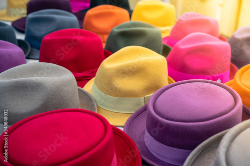 multi-colored hats of different styles on the store counter blurred background