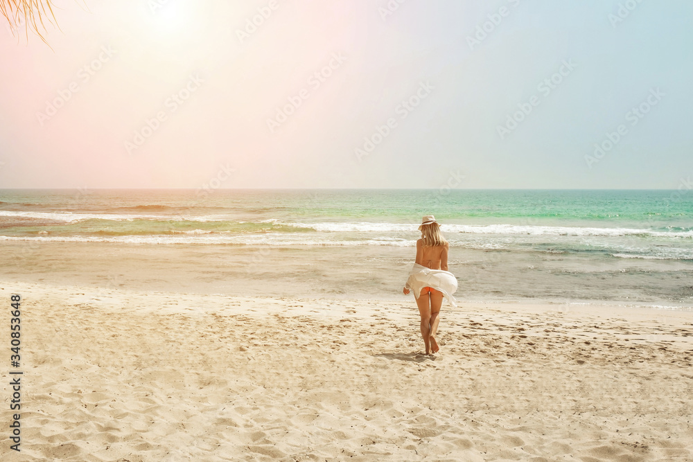 Happy traveller woman in white enjoys her tropical beach vacation Happy traveller woman in white enjoys her tropical beach vacation