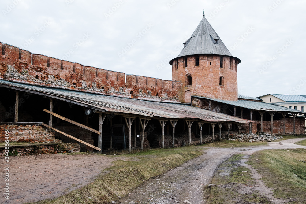 Fototapeta premium The wall of Veliky Novgorod kremlin and archaeological aecavations near it
