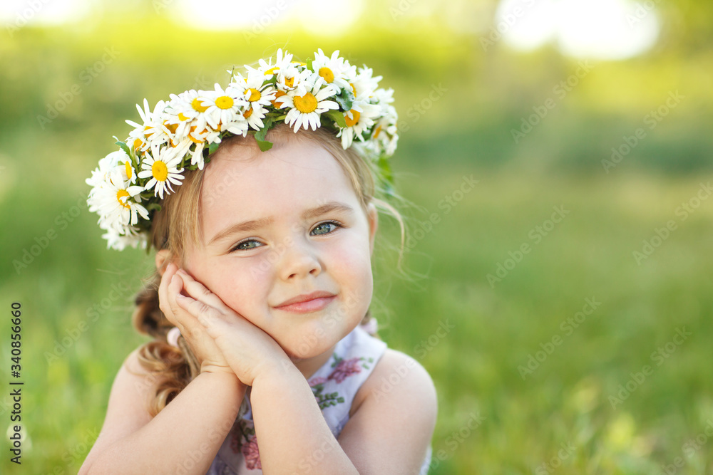 Little girl in nature with a wreath of flowers on her head. Little girl in nature with a wreath of flowers on her head.