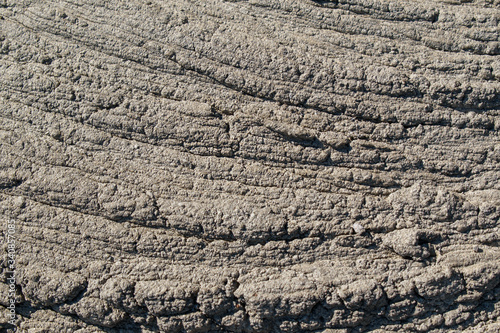 Flow of liquid concrete. Wrinkled surface, sag. Cloudy color. The concept of the skin of a dinosaur, archosaur.