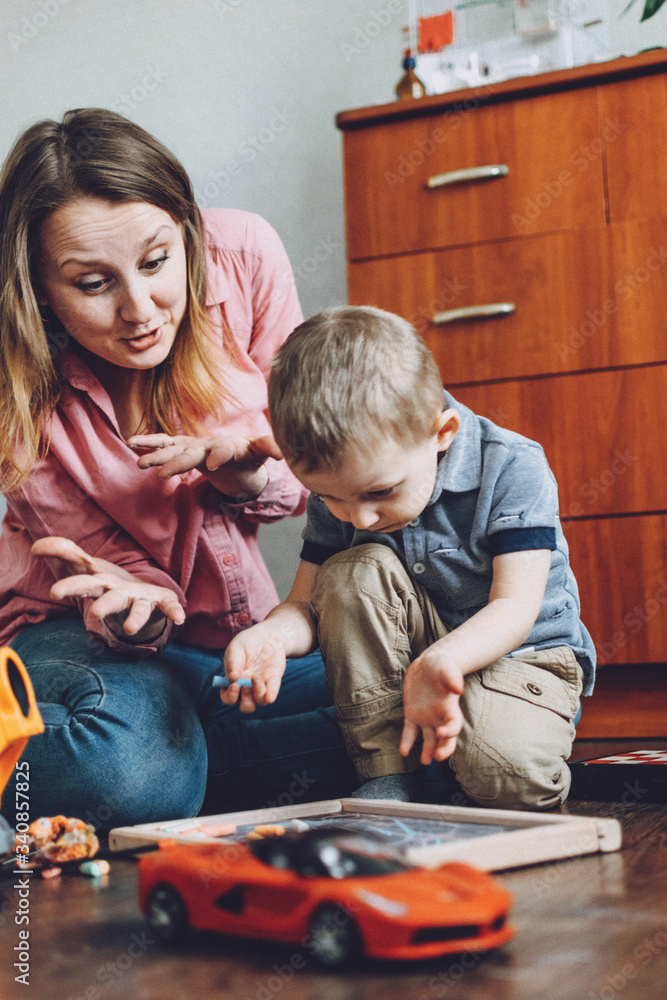Obraz premium Happy mothers day Toddler Child son and mom play at home. Family games, holiday and togetherness. Keeping kids busy. Activities for children