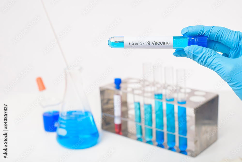 Close up doctor hand is holding covid-19 vaccine in laboratory Close up doctor hand is holding covid-19 vaccine in laboratory