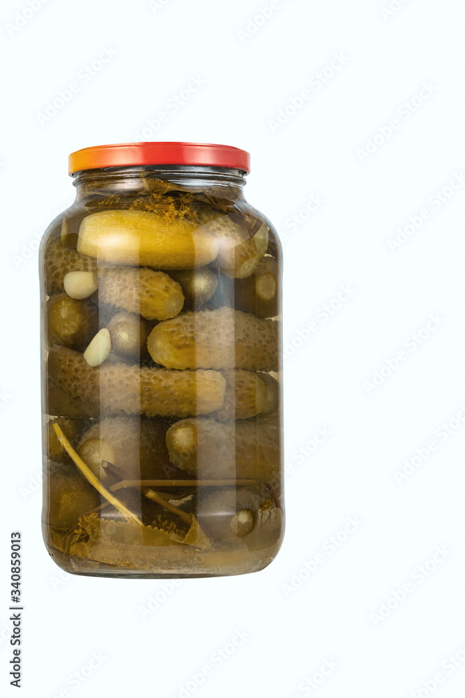 jar of pickles with garlic and herbs isolated on white background jar of pickles with garlic and herbs isolated on white background