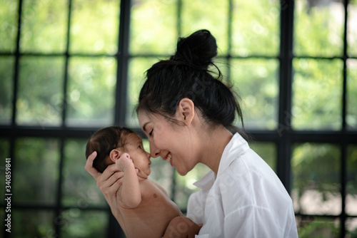 Mother is hugging and showi...