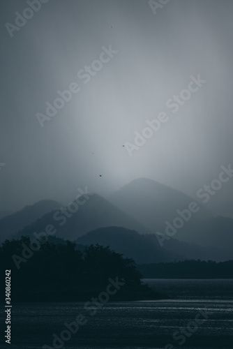 dark tone of mountain layers with lake  tropical forest