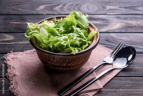 Fresh salad with lettuce and olive oil in a deep piala, on a dining table
