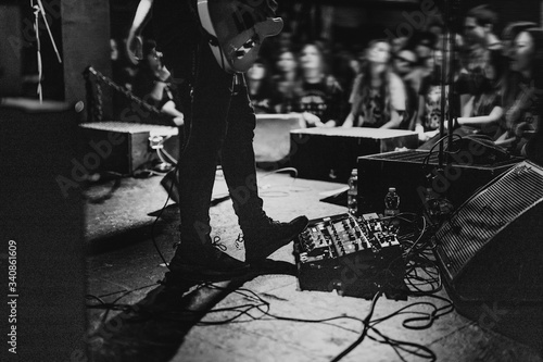 Musician using a pedal board in a concert photo