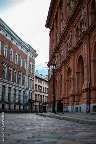 Beautiful Riga city architecture with old buildings and brick streets.