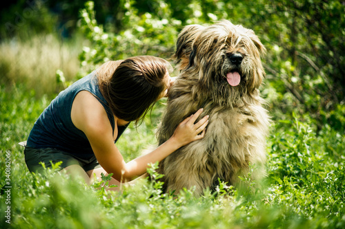 girl with a big shaggy dog in nature