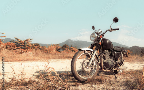 Motorbike under sky. Vintage color photo effect added