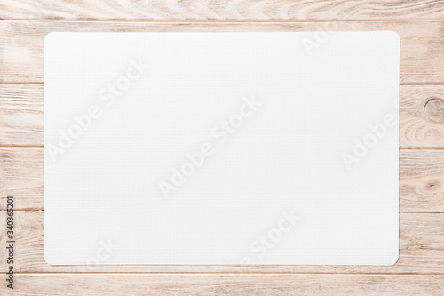 Top view of white table napkin on wooden background. Place mat with empty space for your design photo