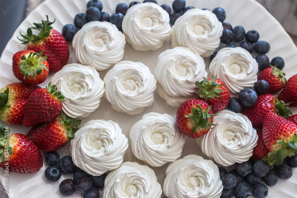 tray with meringues and strawberries