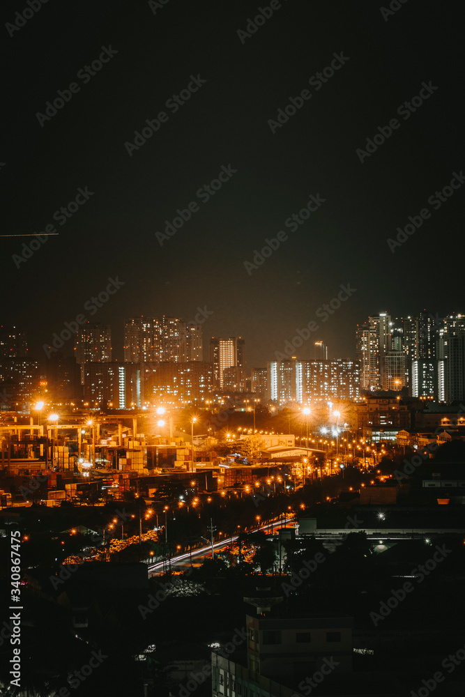 Urban night skyline panoramic view of Ho Chi Minh city. Ho Chi Minh City with development buildings, transportation, energy power infrastructure. View from District 7, Saigon. High resolution 