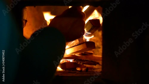 Firewood burns hot in a rustic stove. The old village in the Russian province. 