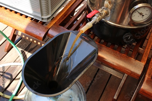 Fototapeta Craft beer being brewed outside. Home brewing concept