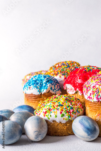 Easter still life with blue eggs and traditional Easter cake. Easter cake decorated with glaze. Easter composition. Colored eggs, copy space photo