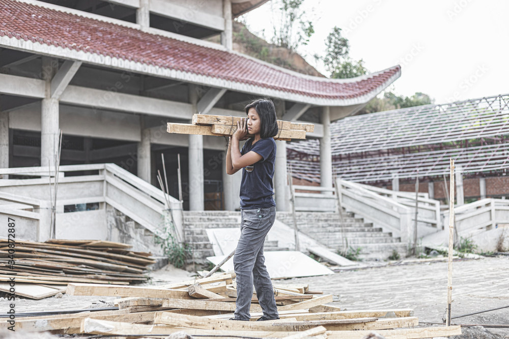 poor young girl working at construction site for world day against child labor concept: poor young girl working at construction site for world day against child labor concept: