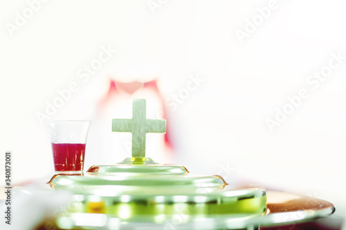 softfocus of cross and red wine communion and easter concept.