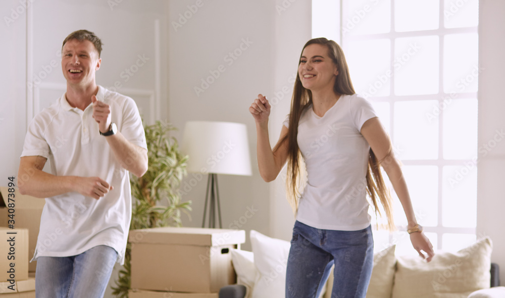 Fototapeta premium Lovely couple dancing in new empty flat
