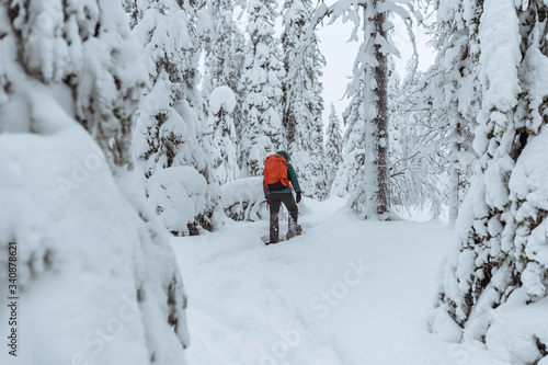 Woman trekking through a snow covered Lapland, Finland © Rawpixel.com