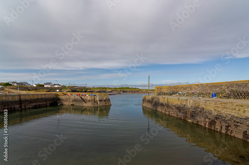 The Inner Harbour entrance at Slade Harbour at low tide on a bright October afternoon with its Quays loaded with Lobster and Crab Pots.