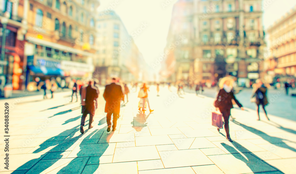 crowd of people walking on sunny streets