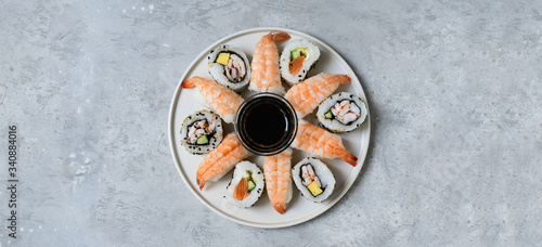 food delivery set of sushi and rolls with salmon and shrimp on the light background, selective focus image. service food order online. 