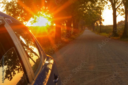 the sun's rays blue cars on the road, the sunset and the car © SeagullNady