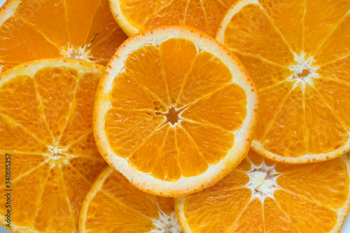 Closeup of sliced juicy oranges textured background
