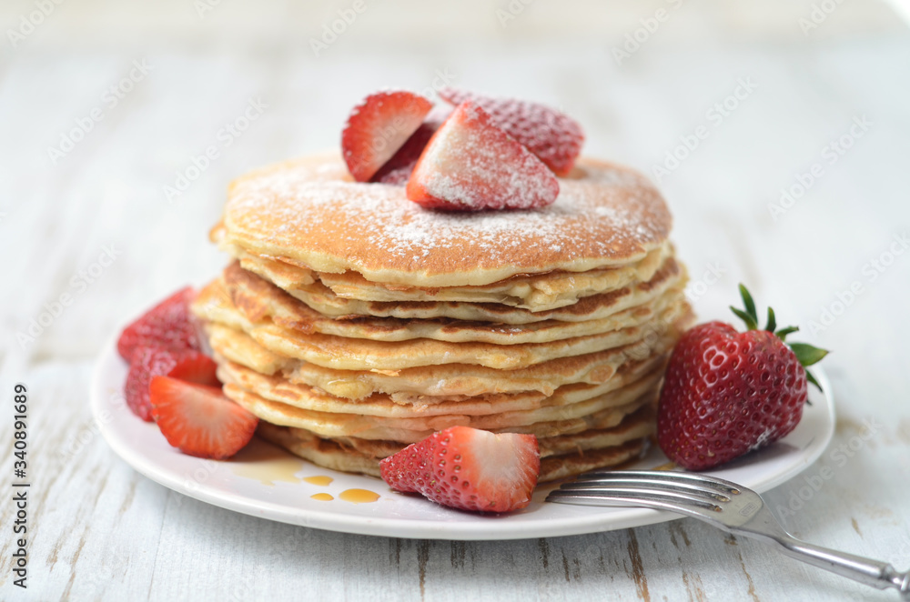 freshly prepared pancakes with strawberries