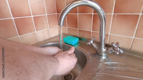 Man disinfects hands with soap and water during the Covid-19 epidemic